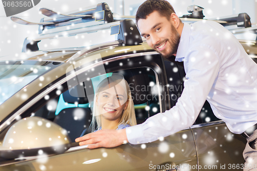 Image of happy couple buying car in auto show or salon