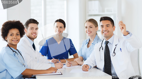 Image of group of happy doctors on conference at hospital