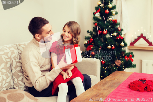 Image of smiling father and daughter looking at each other