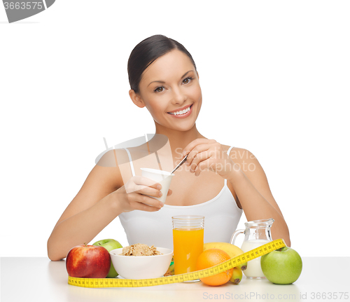 Image of woman with healthy breakfast and measuring tape