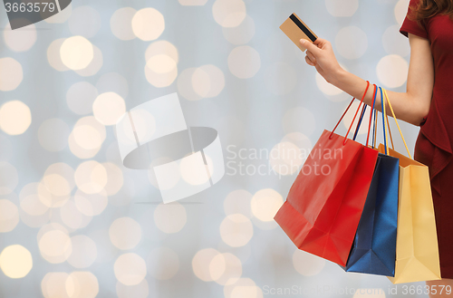 Image of close up of woman with shopping bags and bank card