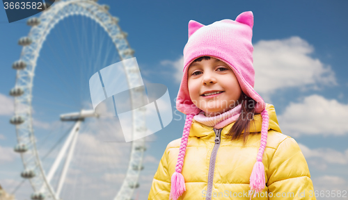 Image of happy little girl over london ferry wheel