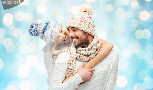 Image of smiling couple in winter clothes hugging