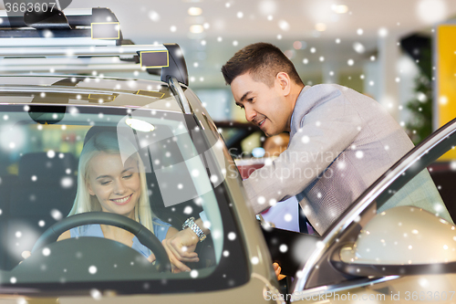 Image of happy woman with car dealer in auto show or salon