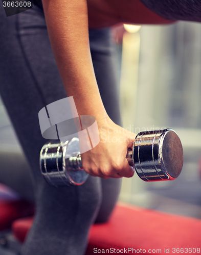 Image of close up of couple with dumbbell exercising in gym