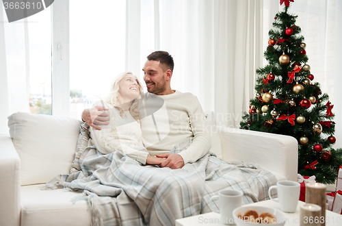 Image of happy couple at home with christmas tree