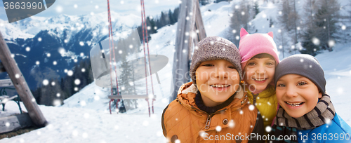 Image of happy children hugging over winter background