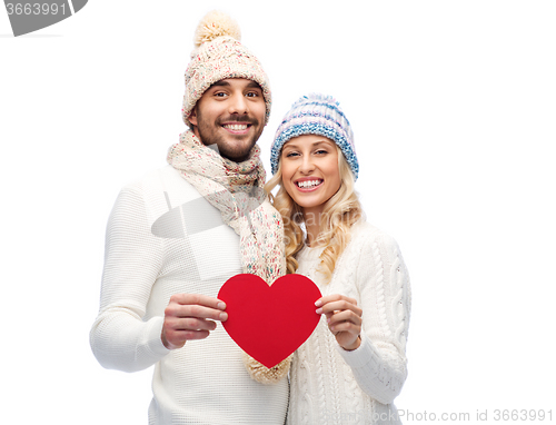 Image of smiling couple in winter clothes with red heart