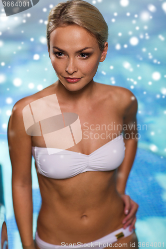 Image of happy woman raising upstairs in swimming pool