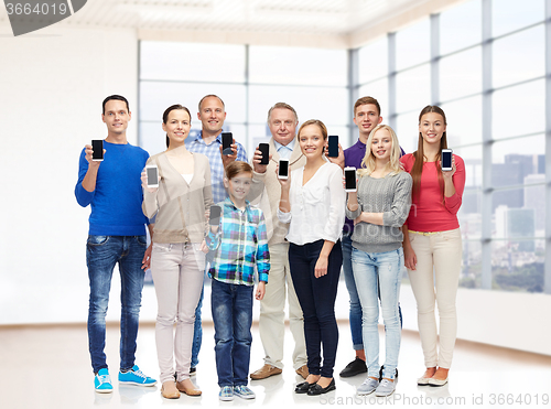 Image of group of smiling people with smartphones