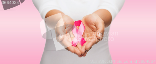 Image of hands holding pink breast cancer awareness ribbon