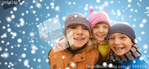 Image of happy children hugging over snow background