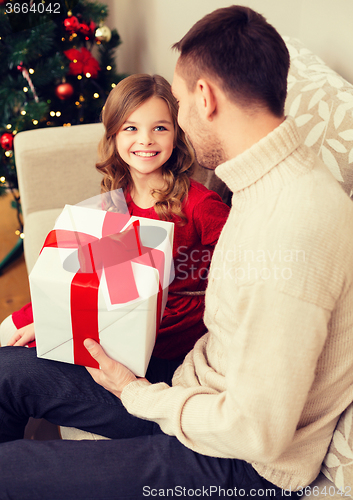 Image of smiling father and daughter looking at each other