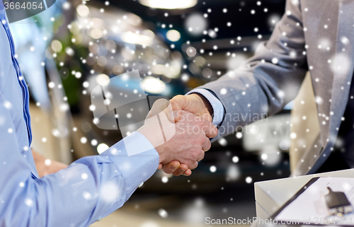 Image of close up of male handshake in auto show or salon