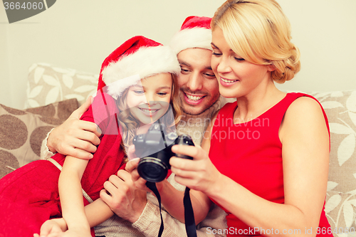 Image of family in santa helper hats looking at pictires