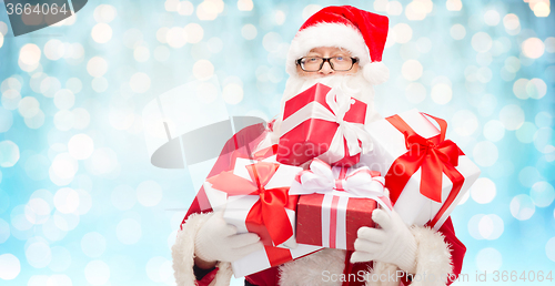 Image of man in costume of santa claus with gift boxes