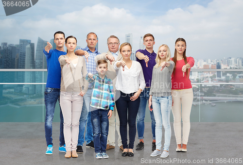 Image of people giving thumbs down over city waterside