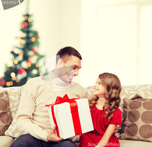 Image of smiling father and daughter looking at each other