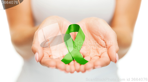 Image of hands holding green awareness ribbon