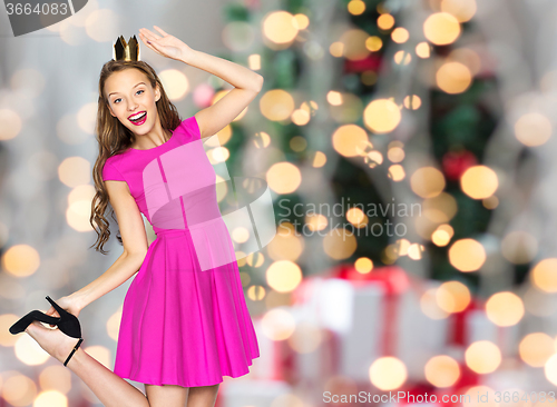 Image of happy woman crown over christmas lights