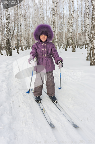 Image of Winter portrait of the girl of four years on skis