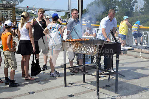 Image of Preparation and sale of shish kebabs on the city street in Tyume