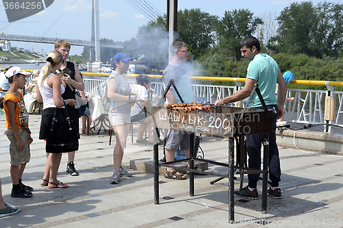 Image of Preparation and sale of shish kebabs on the city street in Tyume