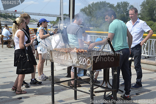 Image of Preparation and sale of shish kebabs on the city street in Tyume