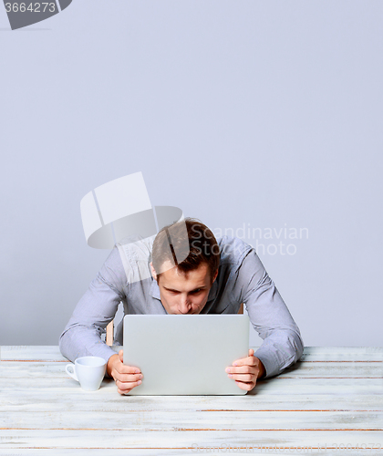 Image of man working on laptop in the office