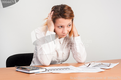 Image of Young attractive student worried over charts
