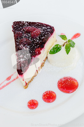 Image of Cheesecake with raspberry sauce and green mint