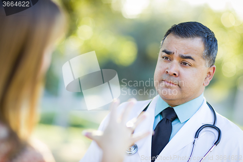 Image of Hispanic Male Doctor or Nurse Talking With a Patient