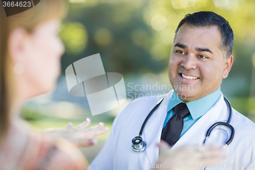 Image of Hispanic Male Doctor or Nurse Talking With a Patient