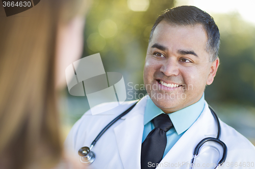 Image of Hispanic Male Doctor or Nurse Talking With a Patient
