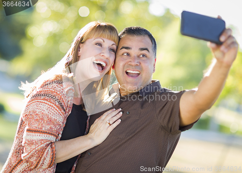Image of Attractive Mixed Race Couple Taking Self Portraits