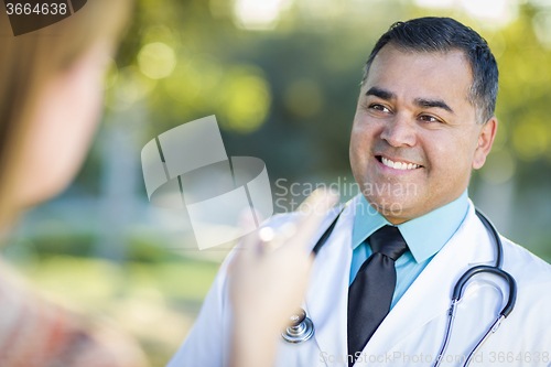 Image of Hispanic Male Doctor or Nurse Talking With a Patient