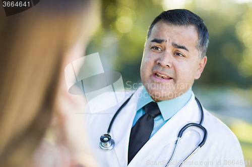 Image of Hispanic Male Doctor or Nurse Talking With a Patient