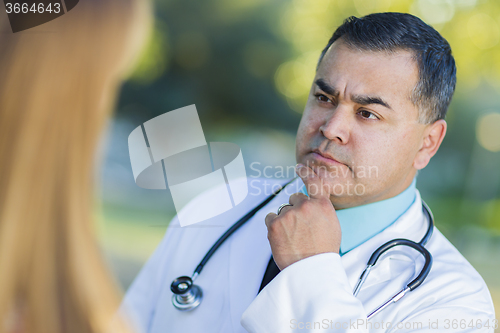 Image of Hispanic Male Doctor or Nurse Talking With a Patient