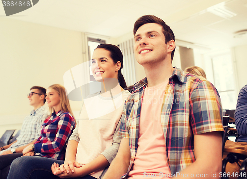 Image of group of smiling students in lecture hall