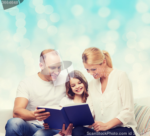 Image of happy family with book at home