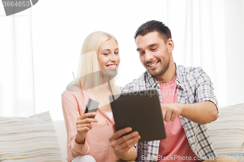 Image of happy couple with tablet pc and credit card