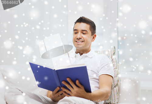 Image of happy man reading book at home