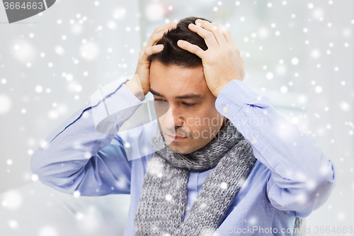 Image of close up of ill man with flu and headache at home