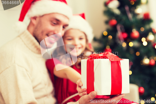 Image of close up of father and daughter with gift box