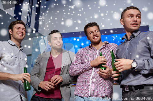 Image of group of male friends with beer in nightclub