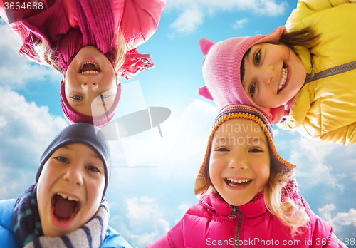 Image of happy little children faces over blue sky