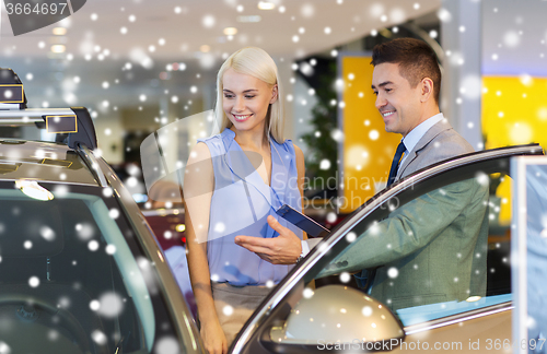 Image of happy woman with car dealer in auto show or salon