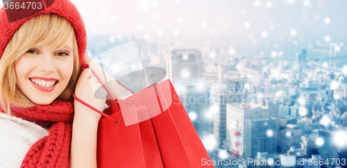 Image of smiling young woman with shopping bags