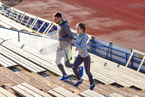 Image of couple running upstairs on stadium