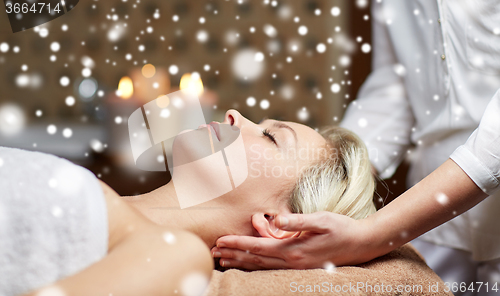 Image of close up of woman having head massage in spa salon